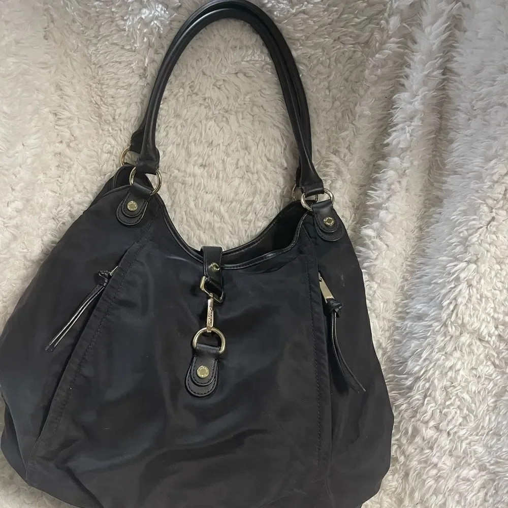 Calvin Klein Black Nylon large shoulder bag with gold tone hardwares.